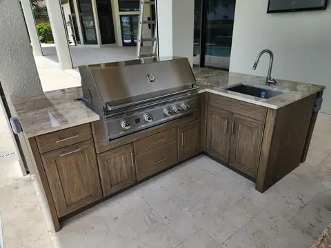 A Naturekast outdoor kitchen with Summerset Grill, sink and trash drawer in Naples, FL. A Naturekast outdoor kitchen with Summerset Grill, sink and trash drawer in Naples, FL.