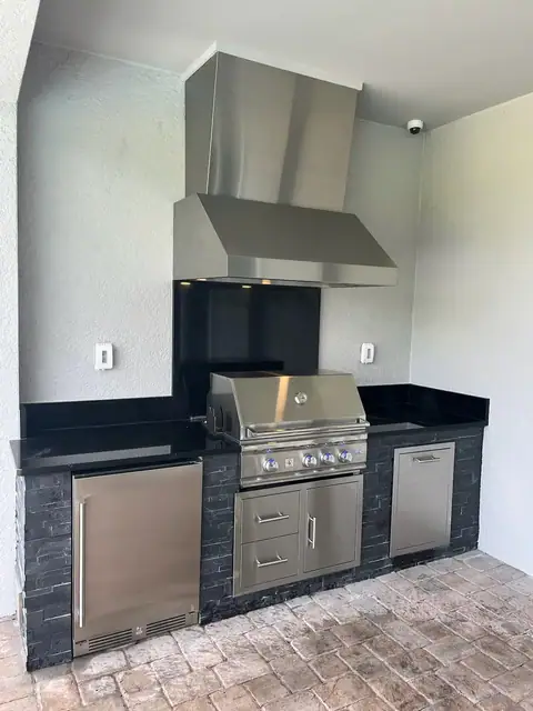 An all black outdoor kitchen with veneer stone built in Cape Coral, Fl. An all black outdoor kitchen with veneer stone built in Cape Coral, Fl.