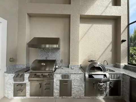 An outdoor kitchen with built in pizza oven. An outdoor kitchen with built in pizza oven.