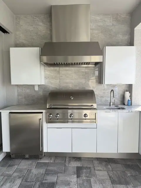 An outdoor kitchen with white cabinets installed in Ft Myers, FL. An outdoor kitchen with white cabinets installed in Ft Myers, FL.