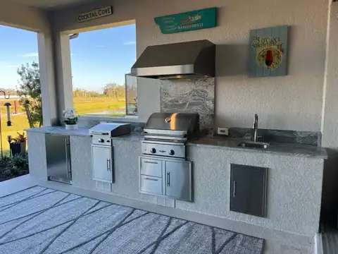 Stucco custom outdoor kitchen in Naples, Fl with Grill, outdoor fridge and vent hood. Stucco custom outdoor kitchen in Naples, Fl with Grill, outdoor fridge and vent hood.