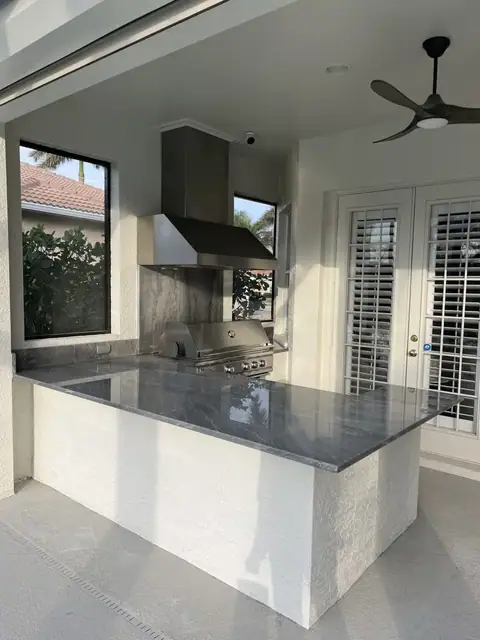 An L shaped outdoor kitchen with bar installed in Naples, FL. An L shaped outdoor kitchen with bar installed in Naples, FL.