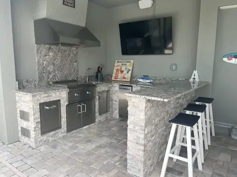 A U shaped outdoor kitchen with stone cladding made in Babcock Ranch, FL. A U shaped outdoor kitchen with stone cladding made in Babcock Ranch, FL.