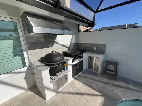 A custom outdoor kitchen with a built in drop down smoker done in Ft Myers, FL. A custom outdoor kitchen with a built in drop down smoker done in Ft Myers, FL.