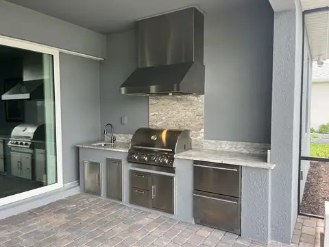 A custom outdoor kitchen with built in drawer fridge done in Naples, FL. A custom outdoor kitchen with built in drawer fridge done in Naples, FL.