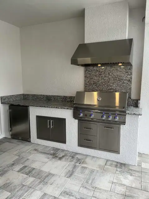 A simple outdoor kitchen with grill and fridge constructed in Naples, FL. A simple outdoor kitchen with grill and fridge constructed in Naples, FL.