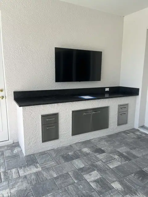 An outdoor cabinet with storage and mounted TV constructed in Naples, FL. An outdoor cabinet with storage and mounted TV constructed in Naples, FL.