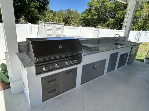 A custom outdoor kitchen with grill and fridge made in Esplanade Lakes, FL. A custom outdoor kitchen with grill and fridge made in Esplanade Lakes, FL.