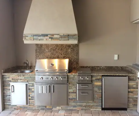 A classic style outdoor kitchen with European style hood surround installed in Ft Myers, FL. A classic style outdoor kitchen with European style hood surround installed in Ft Myers, FL.