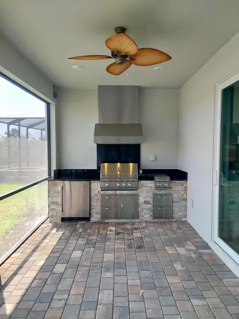 A beautiful outdoor kitchen with dark granite built in Naples, FL. A beautiful outdoor kitchen with dark granite built in Naples, FL, with built in grill, side burner and outdoor fridge.