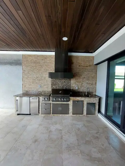 Custom outdoor kitchen with full rear wall stack stone built in Wild Blue, FL. Custom outdoor kitchen with full rear wall stack stone built in Wild Blue, FL.