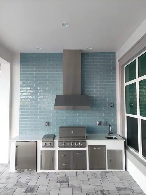 Custom outdoor kitchen with full tile backsplash built in Naples, FL with Grill and side burner. Custom outdoor kitchen with full tile backsplash built in Naples, FL with Grill and side burner.