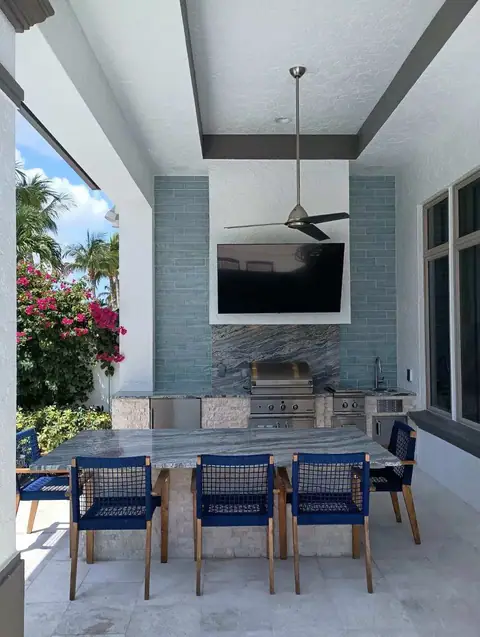 A large custom outdoor kitchen, Bonita Springs, FL. A large custom outdoor kitchen, Bonita Springs, FL featuring a large island and custom hood surround.