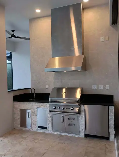 An outdoor kitchen with full tile rear wall installed in Cape Coral, FL. An outdoor kitchen with full tile rear wall installed in Cape Coral, FL.